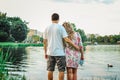 Beautiful couple in love on the background of the lake in the park in summertime closeup