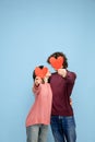 Beautiful couple in love on blue studio background. Valentine's Day, love and emotions concept Royalty Free Stock Photo