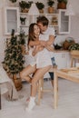 Beautiful couple in love celebreting Christmas. Kitchen breakfast - Image