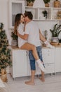 Beautiful couple in love celebreting Christmas. Kitchen breakfast - Image