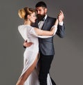 Beautiful couple in love dancing tango with passion. Professional dancers in ballroom.