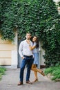 A beautiful couple in love, a guy and a girl, have fun free time, walking through the city streets Royalty Free Stock Photo