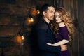 Beautiful couple in love hugging against the background of glowing lights. Studio portrait photo of a girl blondes and a guy with Royalty Free Stock Photo
