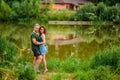 A beautiful couple in love, a man and a woman, embrace on the shore of a summer lake. Amazing natural landscape Royalty Free Stock Photo