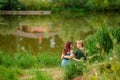A beautiful couple in love, a man and a woman, embrace on the shore of a summer lake. Amazing natural landscape Royalty Free Stock Photo
