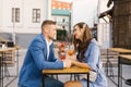 Beautiful couple in love is sitting at a table in an outdoor cafe on a date Royalty Free Stock Photo