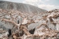 A beautiful couple of lovers posing in a white salt mountain. A young woman in a stylish wedding dress and a beautiful Royalty Free Stock Photo