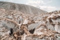 A beautiful couple of lovers posing in a white salt mountain. A young woman in a stylish wedding dress and a beautiful stylish man Royalty Free Stock Photo