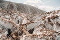 A beautiful couple of lovers posing in a white salt mountain. A young woman in a stylish wedding dress and a beautiful stylish man Royalty Free Stock Photo