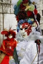 Beautiful couple of masks at St. Mark square during the carnival of Venice. Italy