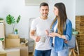 Beautiful couple moving to a new house, smiling cheerful drinking a cup of coffee Royalty Free Stock Photo