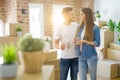 Beautiful couple moving to a new house, smiling cheerful drinking a cup of coffee Royalty Free Stock Photo