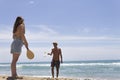 Beautiful couple playing paddle ball on the beach Royalty Free Stock Photo