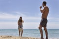 Beautiful couple playing paddle ball on the beach Royalty Free Stock Photo