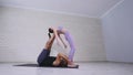 Beautiful couple practicing acro yoga. Young yoga instructors practice in a studio. Two successful young people perform Royalty Free Stock Photo