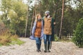 beautiful couple in raincoats with rods going Royalty Free Stock Photo