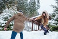 Beautiful couple reaching hands and helping each other in winter