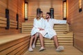 Beautiful couple relaxing in infrared sauna during wellness weekend Royalty Free Stock Photo