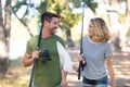 Beautiful couple with rods going from fishing Royalty Free Stock Photo