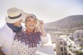 Beautiful couple of senior elderly adult people smiling and enjoying leisure outdoor time in the summer. terrace rooftop with