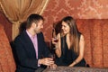 Beautiful couple sitting in a fancy restaurant and talking Royalty Free Stock Photo