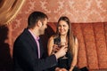 Beautiful couple sitting in a fancy restaurant and talking Royalty Free Stock Photo