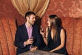 Beautiful couple sitting in a fancy restaurant and talking Royalty Free Stock Photo