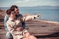 Beautiful couple sitting on the shore of Lake Bracciano. Royalty Free Stock Photo