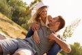 Beautiful couple smiling and sitting on the bench in the park Royalty Free Stock Photo