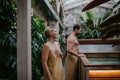 Beautiful couple standing by hot tub, enjoying romantic wellness weekend in spa. Concept of Valentine& x27;s Day.