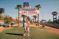 Beautiful couple standing by the Las Vegas sign in Nevada