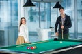 Beautiful couple standing next to the pool table Royalty Free Stock Photo