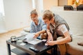 Couple students studying, reading book while sitting on sofa Royalty Free Stock Photo