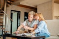 Couple students studying, reading book while sitting on sofa Royalty Free Stock Photo