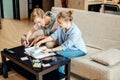 Couple students studying, reading book while sitting on sofa Royalty Free Stock Photo