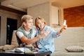 Couple students studying, reading book while sitting on sofa Royalty Free Stock Photo