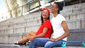 Beautiful couple of stylish teenagers laughing outdoor, skaters subculture