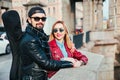 Beautiful couple in sunglasses on the bridge in city . Rock style . Couple in love Royalty Free Stock Photo