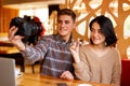 Beautiful couple taking photo in the cafe. Royalty Free Stock Photo