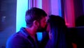 Beautiful couple tenderly kissing at evening party, true love, togetherness Royalty Free Stock Photo