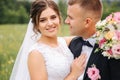 Beautiful couple on their wedding day. Portrait of groom and bride. Green background Royalty Free Stock Photo