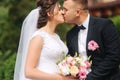 Beautiful couple on their wedding day. Portrait of groom and bride. Green background Royalty Free Stock Photo