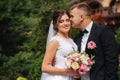 Beautiful couple on their wedding day. Portrait of groom and bride. Green background Royalty Free Stock Photo