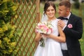 Beautiful couple on their wedding day. Portrait of groom and bride. Green background Royalty Free Stock Photo