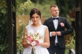 Beautiful couple on their wedding day. Portrait of groom and bride. Green background Royalty Free Stock Photo