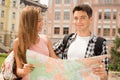Beautiful couple of tourists holding a map in Royalty Free Stock Photo