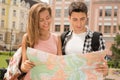 Beautiful couple of tourists holding a map in Royalty Free Stock Photo