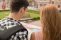 Beautiful couple of tourists holding a map in Royalty Free Stock Photo