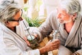 Beautiful couple of two mature adults and senior  having fun and drinking their cocktail between - resort in a hotel - beauty farm Royalty Free Stock Photo