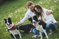 Beautiful couple walking dogs and bonding in nature Royalty Free Stock Photo